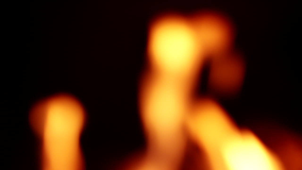 Bokeh Flame From Burning Woods Of A Fireplace Isolated On Black Background