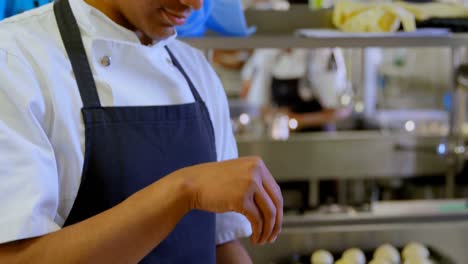 Chef-sprinkling-sugar-on-bowl-in-kitchen-4k