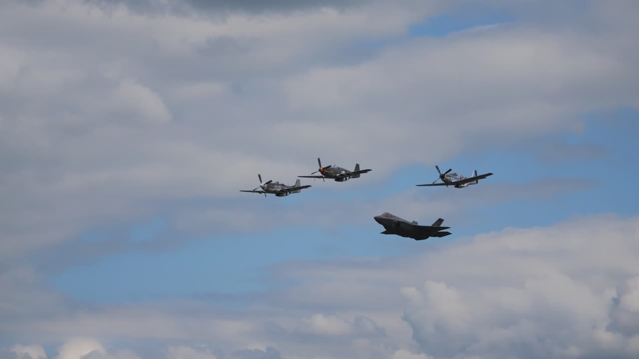 The F 35 military fighter aircraft flies side by side through the air with other aerobatic pilots at the airshow airpower