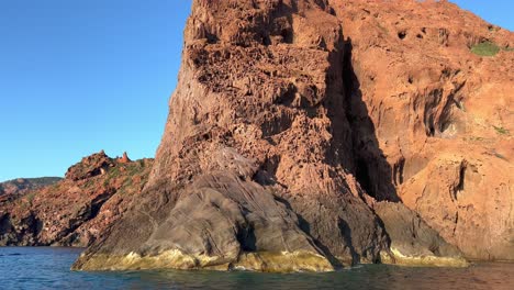 Volcanic-Scandola-famous-nature-reserve-in-summer-season-as-seen-from-moving-boat,-Corsica-island-in-France