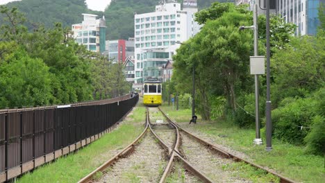 Haeundae-Beach-Train-Travelling-Towards-The-Highrise-Buildings-In-Busan,-South-Korea