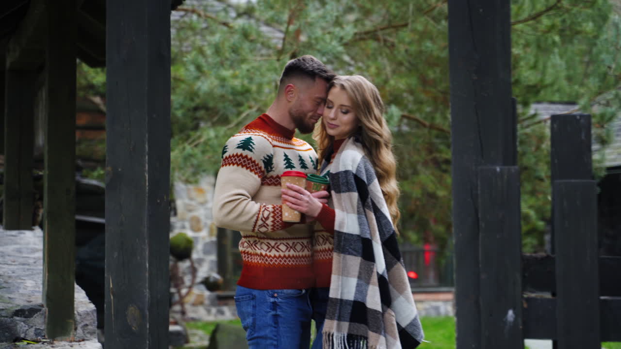 Young couple in love outdoors. Date of happy couple at front yard in autumn. Man and a lovely girlfriend spending romantic time outside in village.