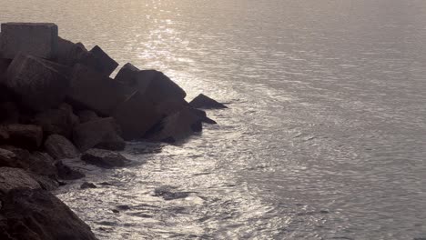 static view of the sea breaking on the jagged coastline. low angle