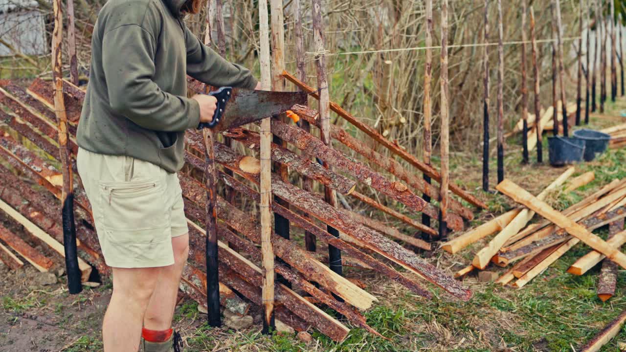 Man Building Skigard (Traditional Fence) In Norway - Wide Shot