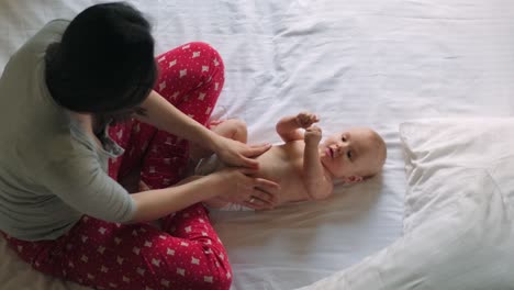 mother doing physical exercises for infant baby. happy mother and baby boy