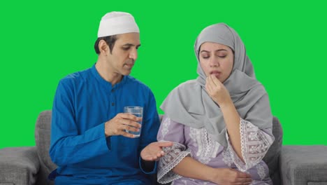 muslim husband giving medicine to his wife green screen