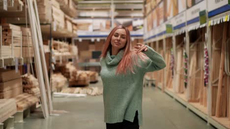 Relaxed-woman-dances-in-hardware-store-between-the-rows