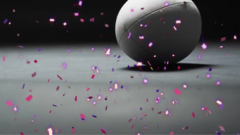 animation of confetti over white rugby ball on black background