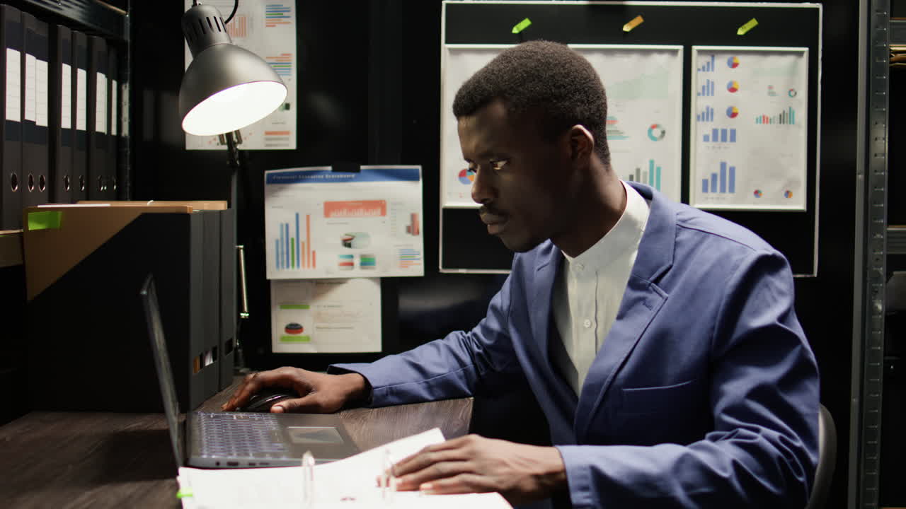 Man Working in Dark Office