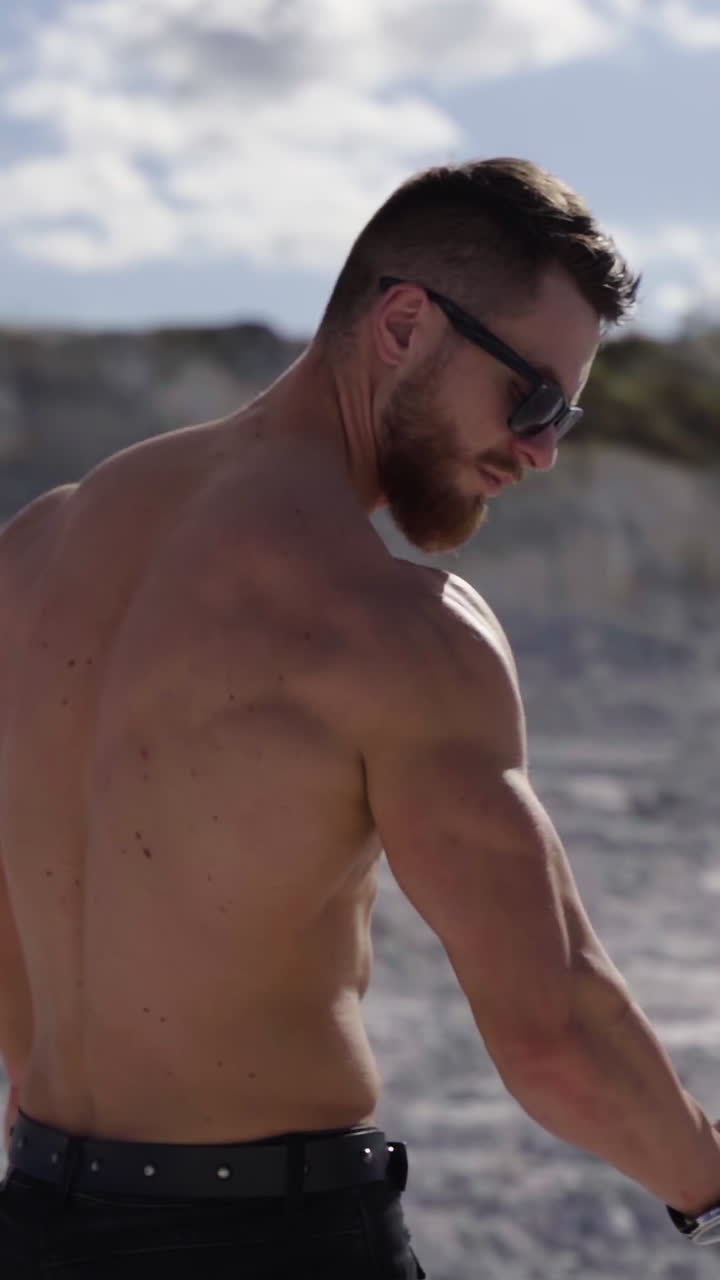 Sexy man posing outdoor. Shirtless young bodybuilder posing on nature