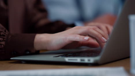 Businesswoman hands typing on laptop computer