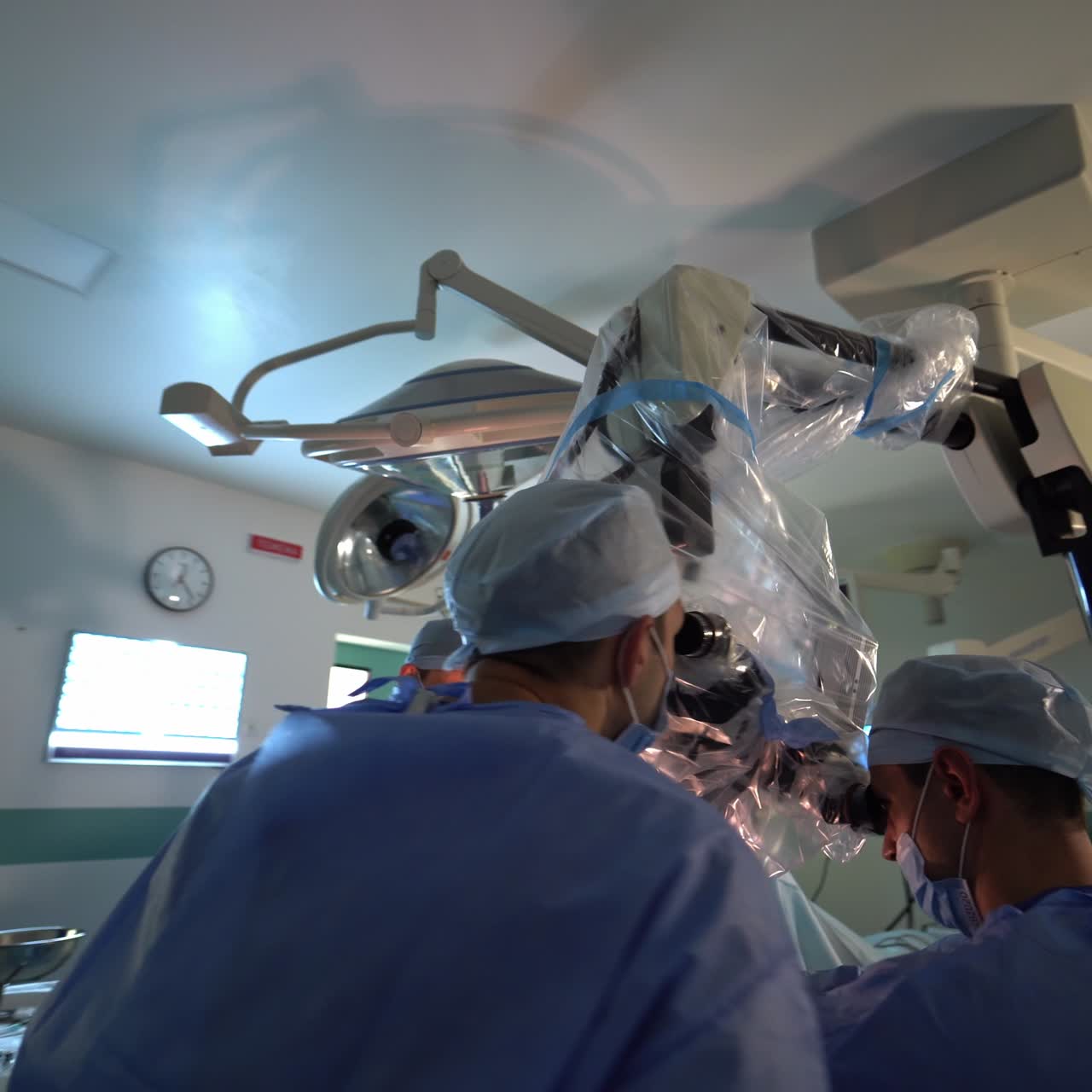 Surgery room with a huge microscope for high-precise operations. Professionals running the surgery. Circle motion