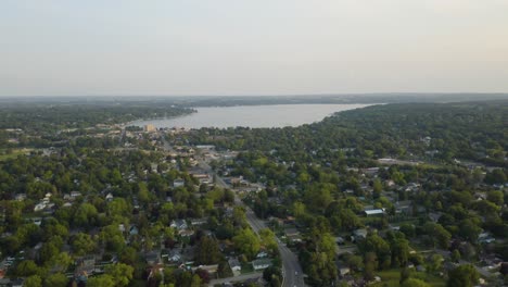Cinematic-Aerial-Shot-of-Downtown-Lake-Geneva,-WI-with-Lake-in-Background