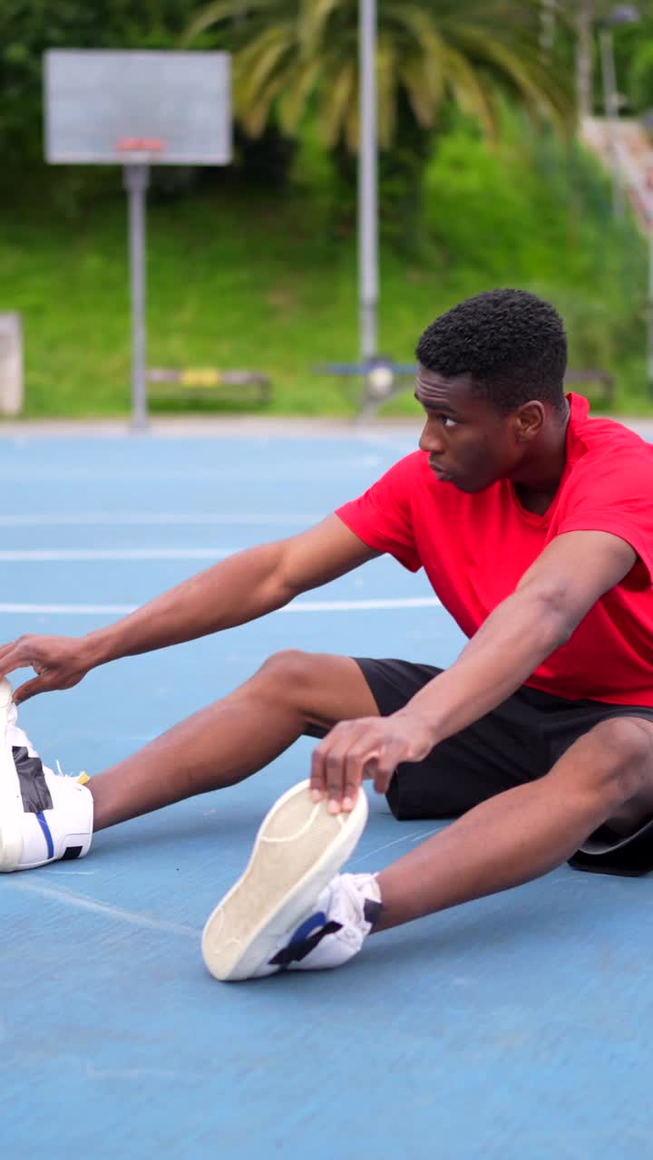 Man stretching on a basketball court