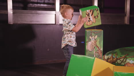 Young-Happy-Boy-Stacking-Up-Large-Soft-Play-Blocks