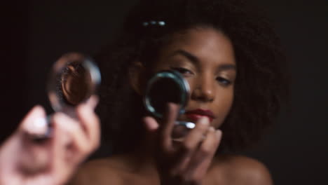 black woman, makeup and round mirror in hands