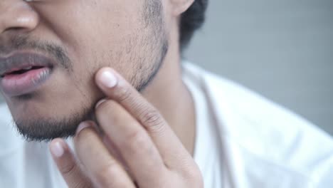 man touching his face with concern