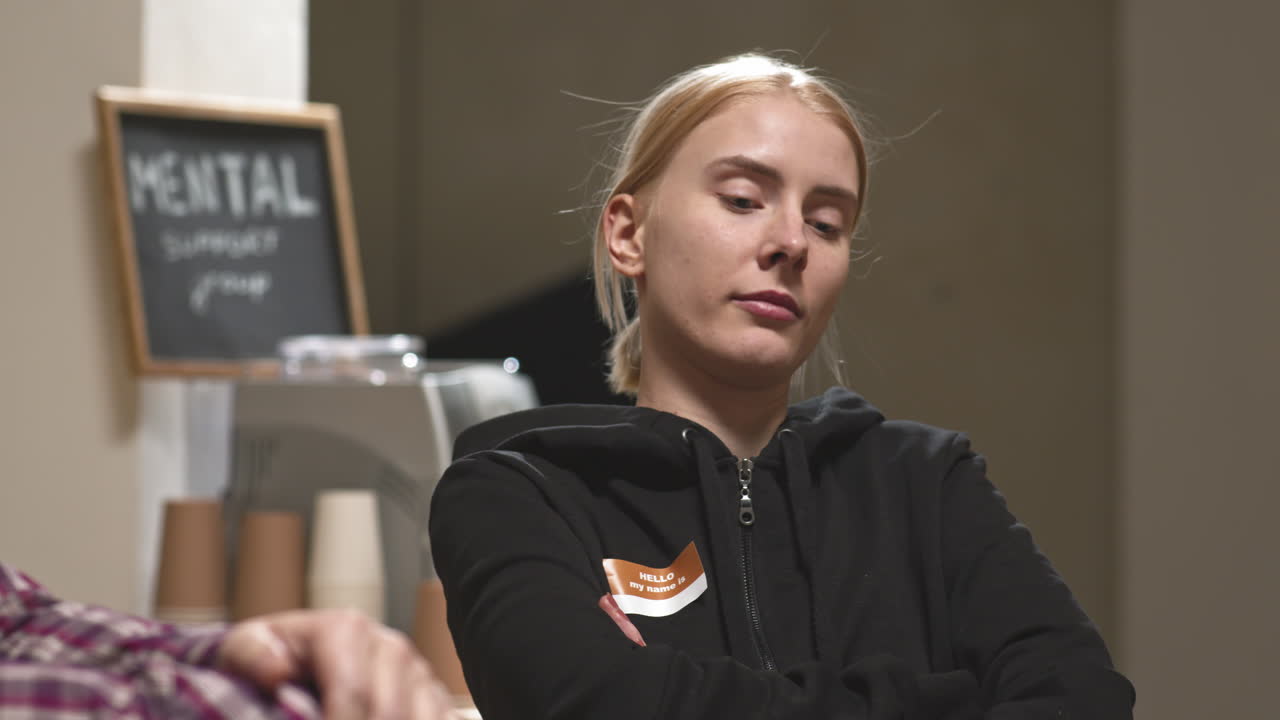 Stressed Young Woman at Group Therapy Session