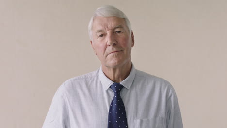 portrait of serious elderly businessman standing expressionless