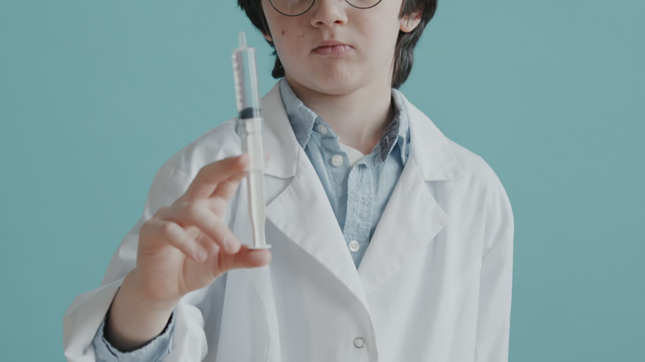 Portrait of Boy in Doctor Costume Holding Syringe
