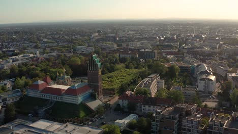 Low-angle-approaching-Darmstadt-with-the-Mathildenhoehe-and-the-city-in-the-background-with-a-drone-on-a-sunny-summer-day