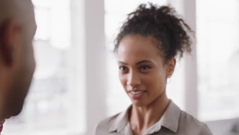 beautiful mixed race business woman chatting with clients smiling enjoying developing corporate partnership discussing project in modern office workspace