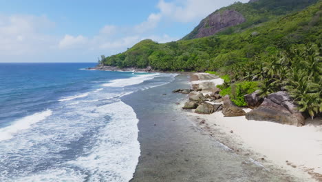 Aerial-drone-view-of-rocky-coastline-on-Silhouette-Island-in-the-Seychelles,-Indian-Ocean