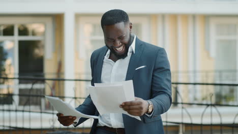 male professional examining documents outside