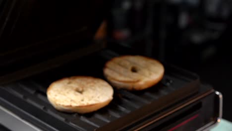 chef toasting bagels slow motion take it out ot the maker