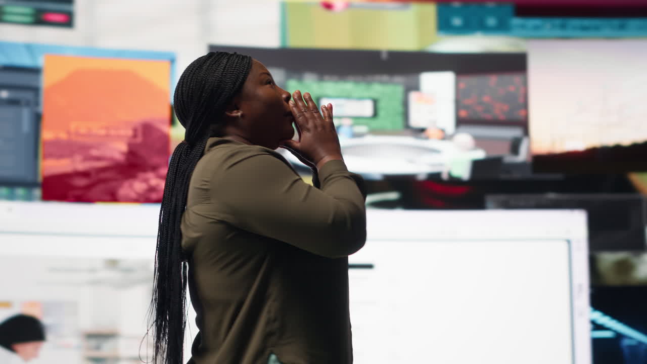 Woman embraces abundance of video content displayed on digital wall