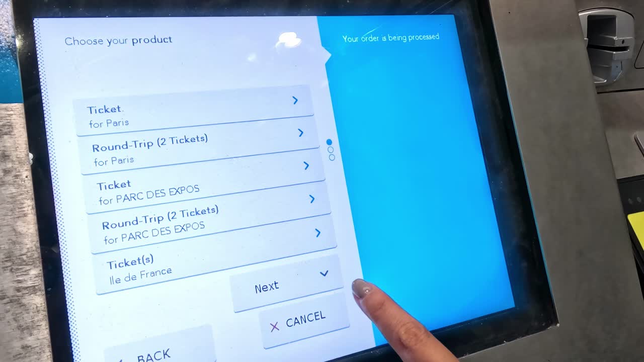 A person navigates a touchscreen interface to choose ticket options and quantities.