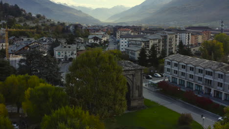 a mesmerizing view of the valle d’aosta, with the amazing arch of augustus, a monument in the city of aosta, northern italy, a drone view
