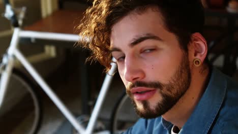 Portrait-of-man-sitting-in-cafe