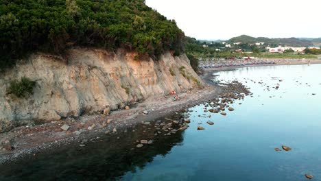 wooded high cliff and rocky beach of the adriatic sea