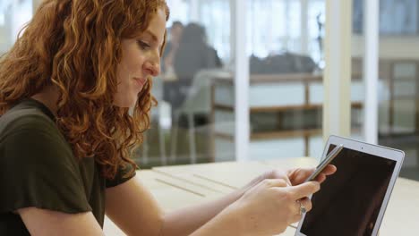 Businesswoman-using-mobile-phone-at-desk-4k