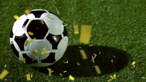 fußball auf gras mit fallendem konfetti