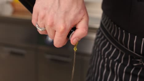 chef pouring olive oil