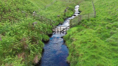 Forward-aerial-view-of-Dane-river-flowing-with-gen-fields-on-either-side-in-England