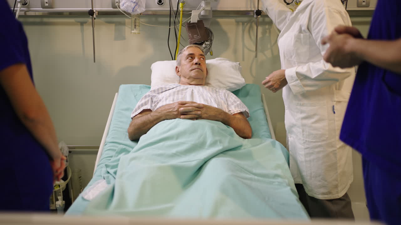 Patient in a Hospital Bed Surrounded by Medical Staff