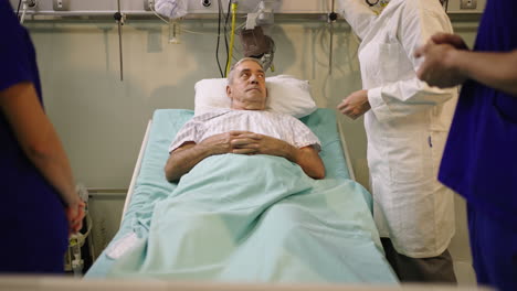 patient in a hospital bed surrounded by medical staff