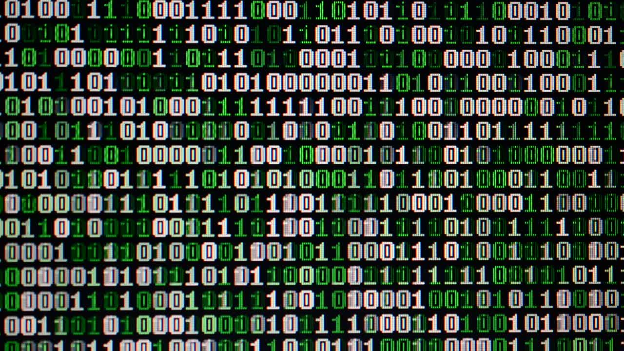 Binary code on the monitor screen. Shooting of a binary code, background