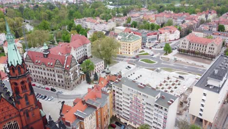 red exterior of legnica cathedral with city office and streets in poland