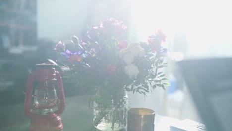 a bouquet of flowers placed in a clear glass vase on a coffee table