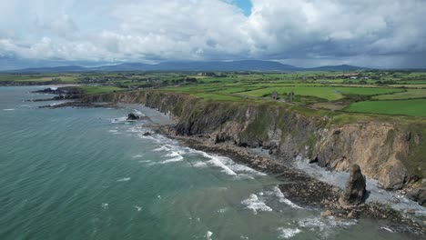 Impresionante-Vista-Del-Mar-Y-Las-Montañas-Costa-De-Cobre-Waterford-En-Un-Día-Siempre-Cambiante-De-Lluvias-Y-Sol-A-Mediados-De-Julio-Por-La-Mañana