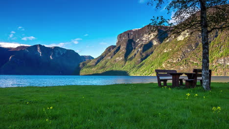 a picnic table by a picturesque fjord in the scandinavian mountains - time lapse