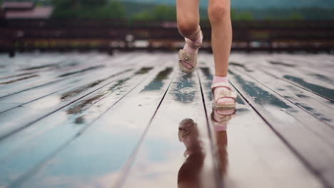 little child runs to camera and stamps feet in small puddles