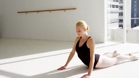 Ballerina-performing-stretching-exercise