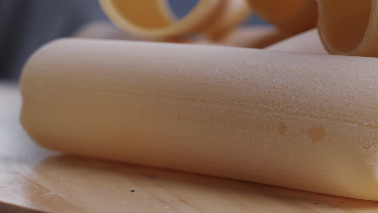 Close Up of Uncooked Tubular Pasta on a Wooden Surface
