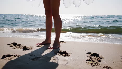 a person holding a jar on the beach