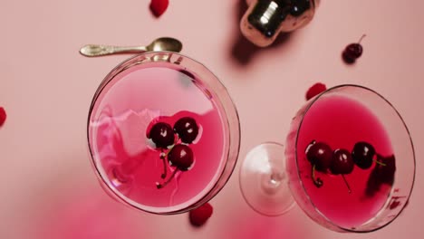 Close-up-of-drinks-with-cherries-and-shaker-on-white-background